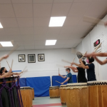 Trainees practicing with Soh Daiko members in down-stand style