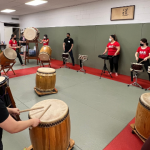 A jam session with former members, current members, and trainees.