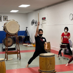 Trainees performing for an audience of current and former members.