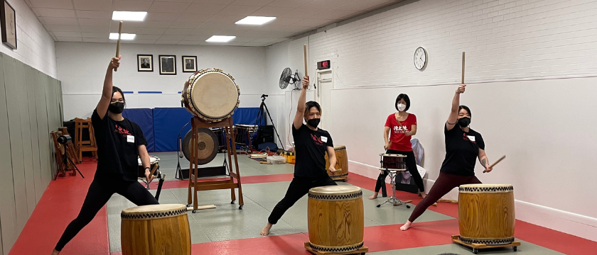 Trainees performing for an audience of current and former members.